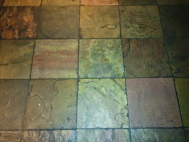 Before a completed grout cleaning service project in the area